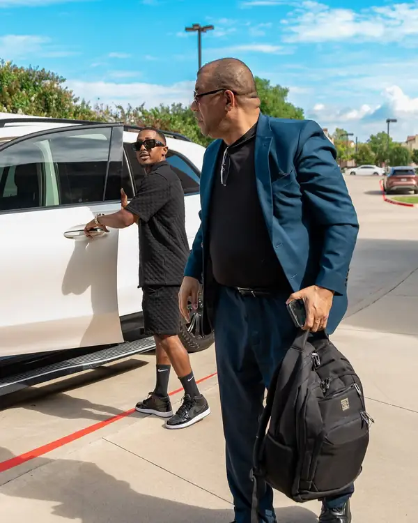 TIED chauffeur opening the door for an executive client
