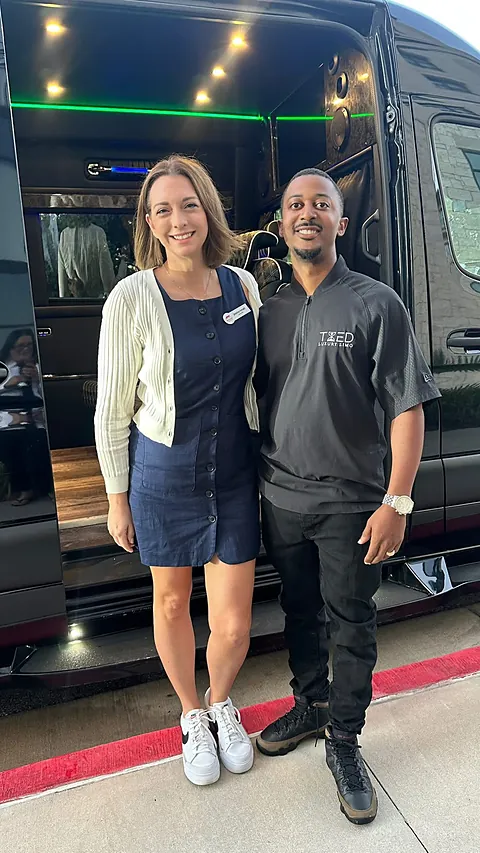 Couple at the LED-lit door of a TIED party bus